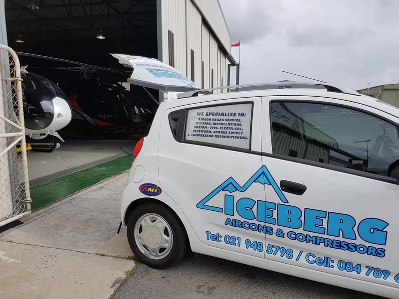 The branded Iceberg car outside a helicopter hangar