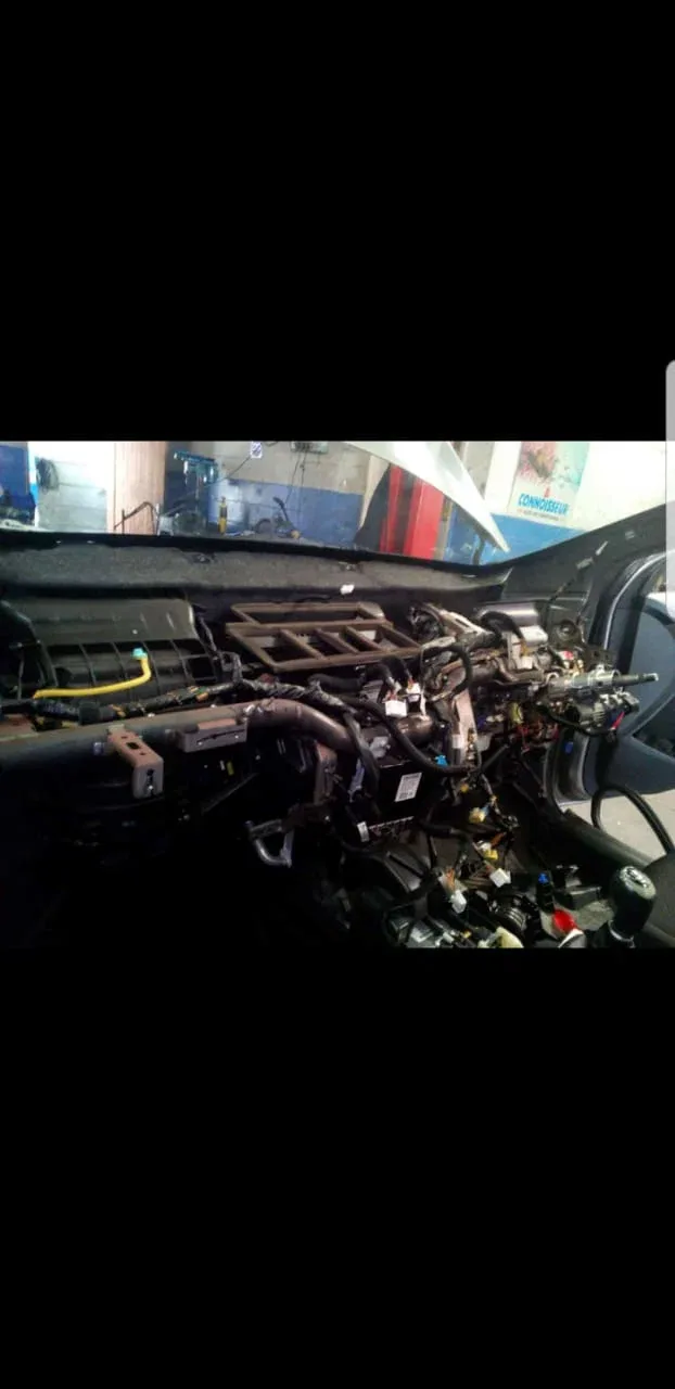A car dashboard stripped out to reach the heater and evaporator behind it