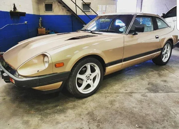 A gold Datsun 280ZX in the workshop