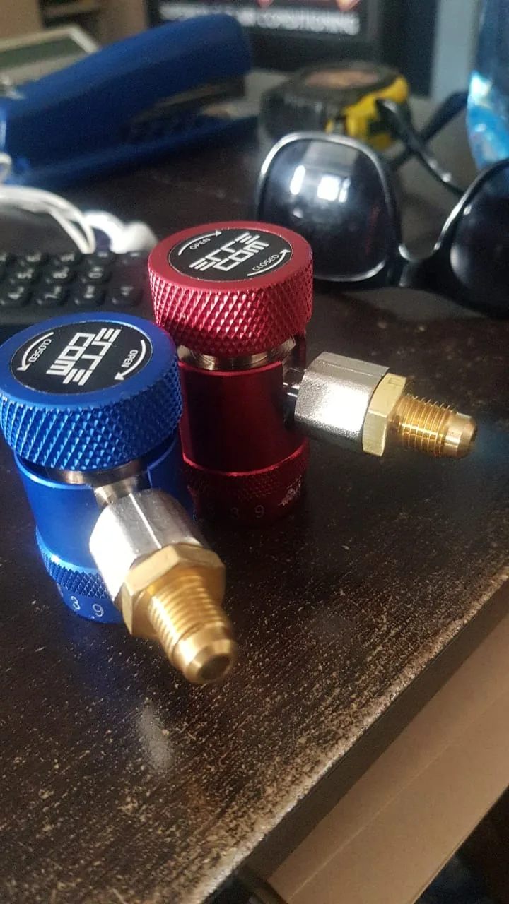 Red and blue R134a quick-coupler fittings on a workbench