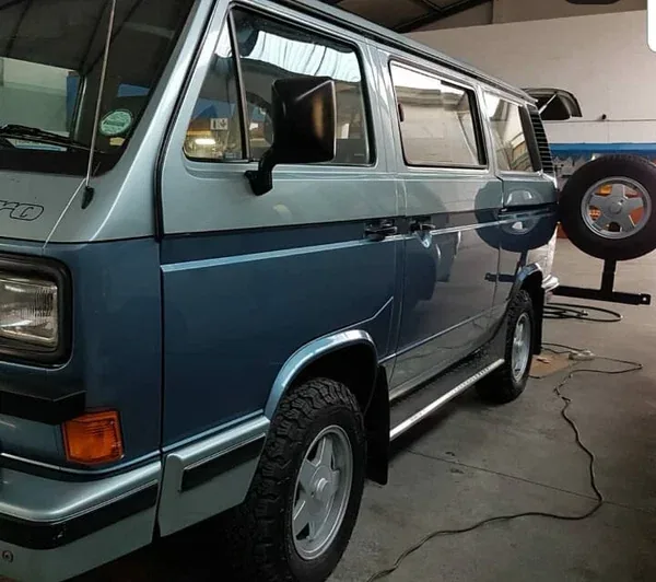 A blue VW T3 Caravelle in the workshop